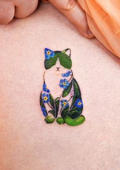 a woman's stomach with a tattoo of a cat and blue flowers on it