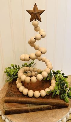 a christmas tree made out of eggs sitting on top of a wooden table next to an old book