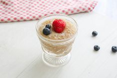 a bowl of oatmeal with berries and blueberries