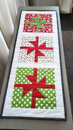 Christmas parties are more festive with this adorable Christmas reversible quilted tablerunner.  Great hostess gift idea, dining table decor, side table decor, Christmas party decor, guest room decor or can be hung for wall art. The holiday Christmas packages feature snowflakes and polka dots in red, green and white and scampering mice with Santa hats on the reverse side.  Measures 32" x 12" and features hand-stitched binding for an elegant look. Made of 100% cotton with a cotton/polyester blend batting. Spot cleaning is recommended to maintain the integrity of the table runner. Since it is made of 100% cotton, it will shrink some upon washing. If necessary, wash in cold water on gentle cycle, air dry, and press with a cool/warm iron. Speedy, free shipping in a box! Thank you for stopping Xmas Table Runners Quilted, Christmas Runners Table, Runner Christmas Gifts, Quilted Runners, Christmas Decor Table, Quilted Christmas Gifts, Xmas Table Runners, Christmas Packages, Christmas Table Runner Pattern