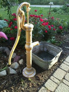 an old water pump has been turned into a bird bath