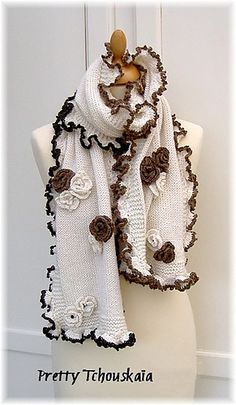 a white scarf with brown flowers on it