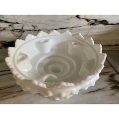 a white bowl sitting on top of a marble counter