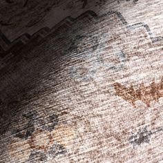 an old rug is shown with some faded paint on it's edges and the floor