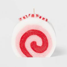 a red and white lollipop with the letter g on it's side