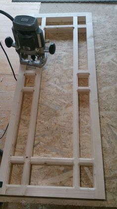 a router is sitting on top of plywood planks in the process of being built