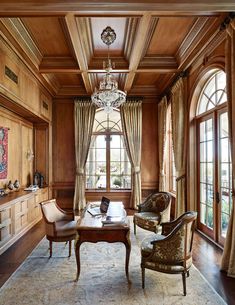 an elegant living room with wood paneling and chandelier