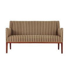 a brown and white striped couch sitting on top of a wooden frame with no legs