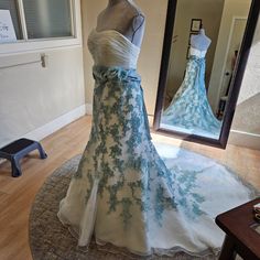 a dress on display in front of a mirror