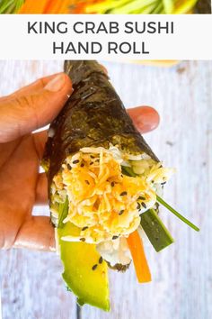 a hand holding a vegetable sushi roll with text overlay that reads king crab sushi hand roll