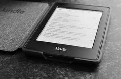 a kindle sitting on top of a table next to another kindle computer device