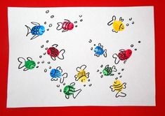 an image of children's artwork with fish and bubbles on it, in the middle of a red background