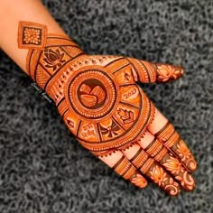 a henna on someone's hand with intricate designs