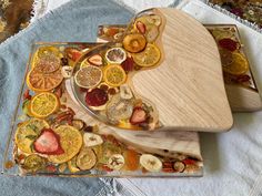 two trays filled with sliced fruit on top of a table next to each other