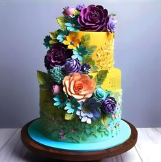 a multi - tiered cake decorated with flowers and leaves