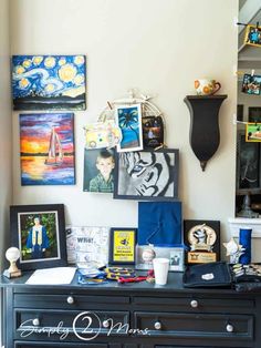 a black dresser topped with pictures and other items