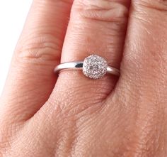 a woman's hand with a diamond ring on it