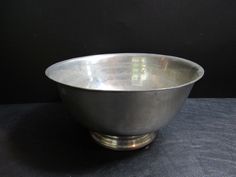 a metal bowl sitting on top of a table