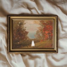 a painting hanging on the wall above a bed