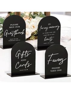 three black and white signs with the words gifts and cards written on them are sitting next to each other