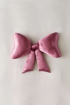 a large pink bow on top of a white surface