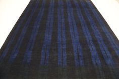 a blue and black striped rug on the floor