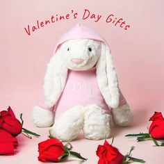 a white stuffed rabbit sitting in front of roses with the words valentine's day gifts written on it