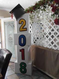 a graduation decoration made out of blocks with numbers on them