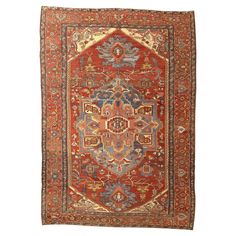 an antique persian rug with red and blue colors