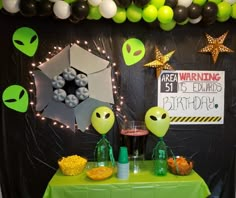 an alien themed birthday party with balloons and decorations