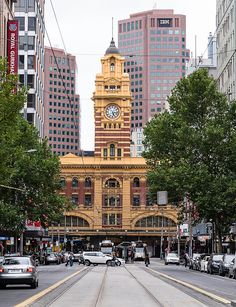 a large clock tower towering over a city street