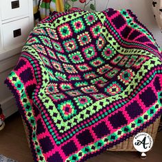 a crocheted blanket sitting on top of a basket