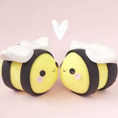 two yellow and black bees with hearts in the background