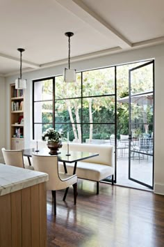 an open kitchen and dining room area with sliding glass doors