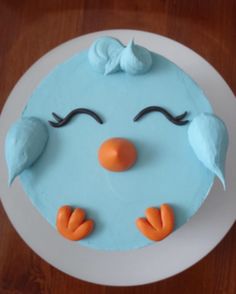 a cake with blue frosting and orange icing