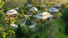 an aerial view of several houses surrounded by trees