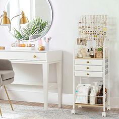 a white desk with a mirror, chair and other items on it in a room