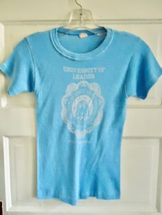 "nice little alumni shirt from the 70s...paperthin and well worn in..Very Good DISTRESSED Vintage Condition...SOLD AS IS...thanks!! **DISTRESSED means there are imperfections that give the shirt character such as holes,stains,nubs, etc...NO RETURNS.** Measurements(Lying flat) Pit to pit:(across chest/bust) 13.5\"..(will stretch up to 15\") Top to bottom: 21.5\"(neck at tag to front hem) Tag: Photo 3 Original size: L estimated size: Today's XS/S(READ MEASUREMENTS) ATTN: PLEASE PAY CLOSE ATTENTION Vintage Screen Print Tops For College, Vintage Tops For College, Tag Photo, The 70s, Vintage 70s, Graphic Prints, Statement Pieces, Seattle, Print T Shirt