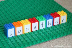 lego blocks spelling out the word jonathan on top of each other in front of a green mat