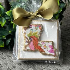 a decorated cookie sitting on top of a plastic bag next to a potted plant