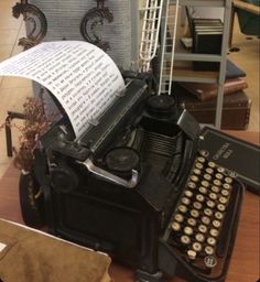 an old fashioned typewriter sitting on top of a table next to a pile of books