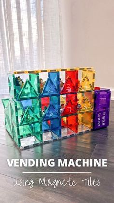 the building blocks are stacked on top of each other with text overlay reading vending machine using magnetic tiles