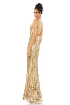 a woman wearing a gold gown with an open back and sequins on it