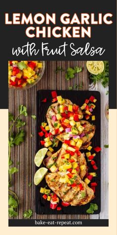 grilled chicken with fruit salsa on a black plate next to limes and cilantro