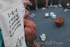 a group of people sitting on top of a floor next to each other with dice in front of them