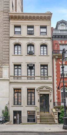 an old brick building with many windows and balconies on the second floor is shown