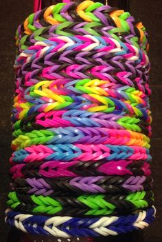 many different colored bracelets stacked on top of each other