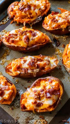 baked sweet potatoes with cheese and bacon on a baking sheet, ready to be eaten