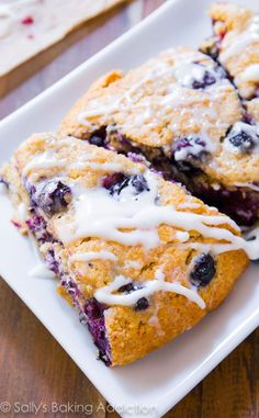 blueberry scones with icing on a white plate