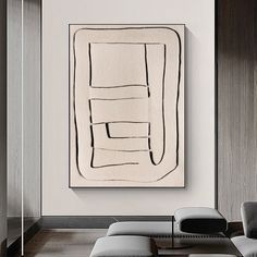 an abstract painting hangs on the wall in a living room